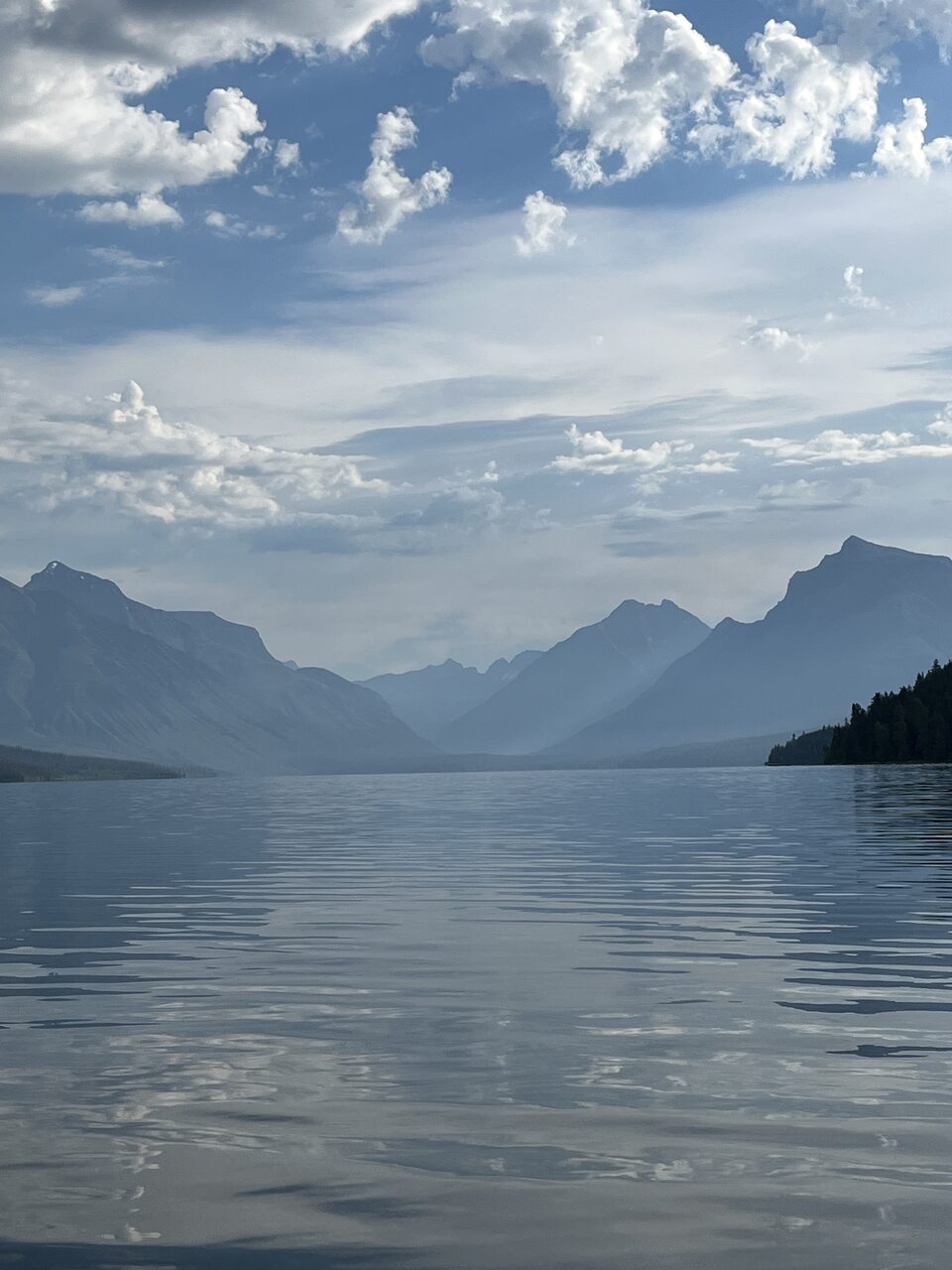 Lake McDonald and McDonald Creek in Glacier National Park, photographed from the water in July 2026