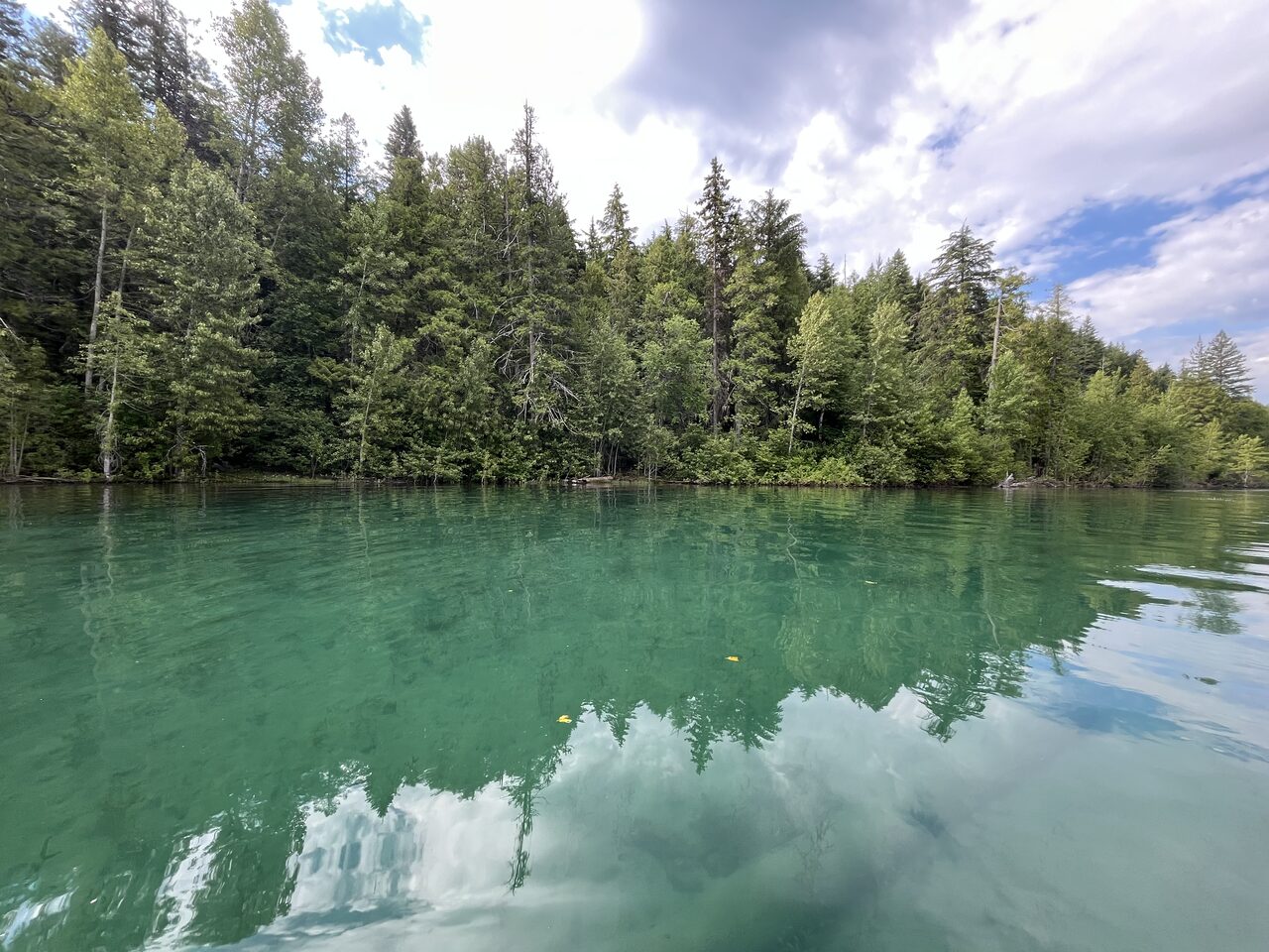 Lake McDonald and McDonald Creek in Glacier National Park, photographed from the water in July 2026