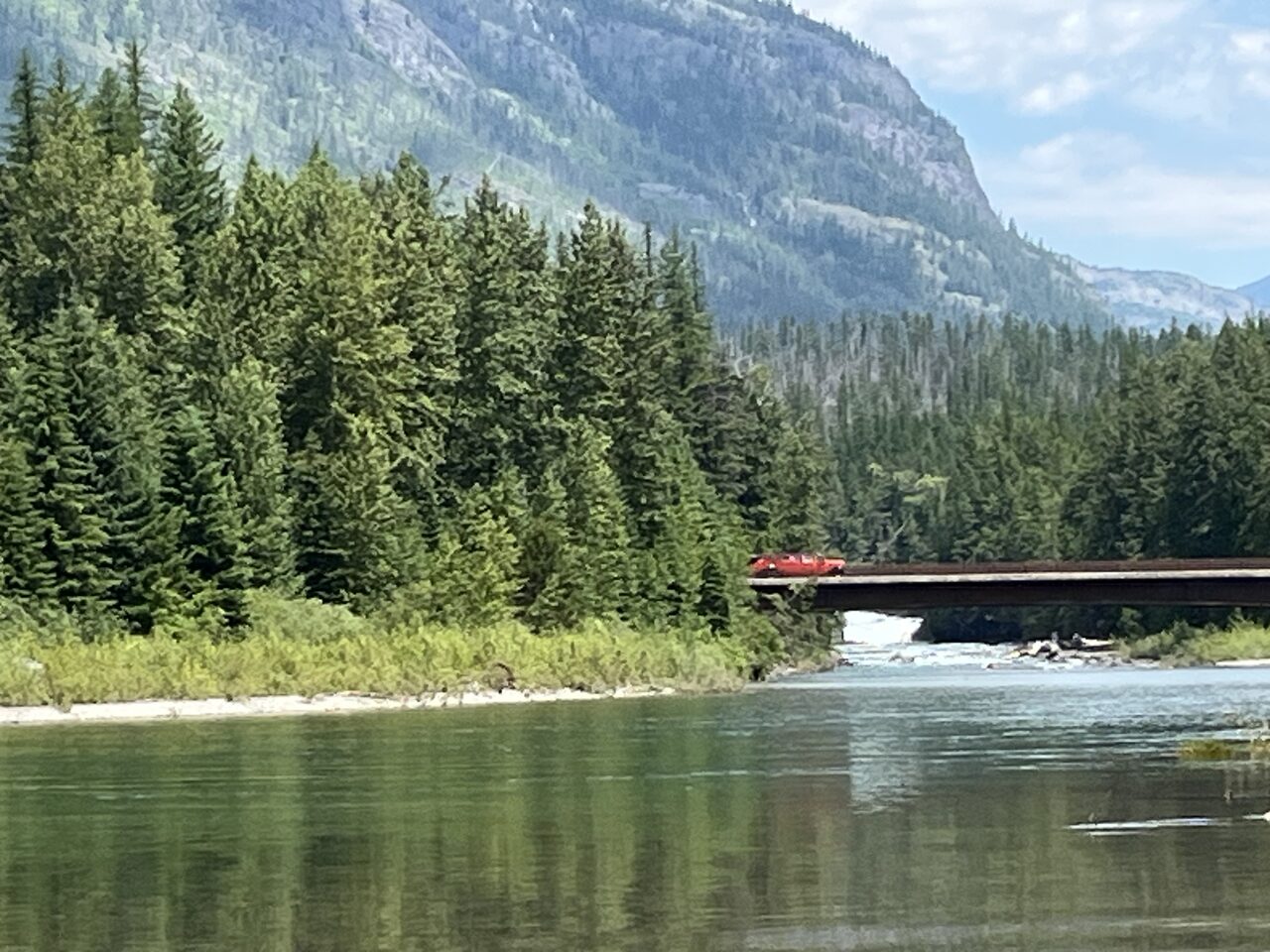 Lake McDonald and McDonald Creek in Glacier National Park, photographed from the water in July 2026