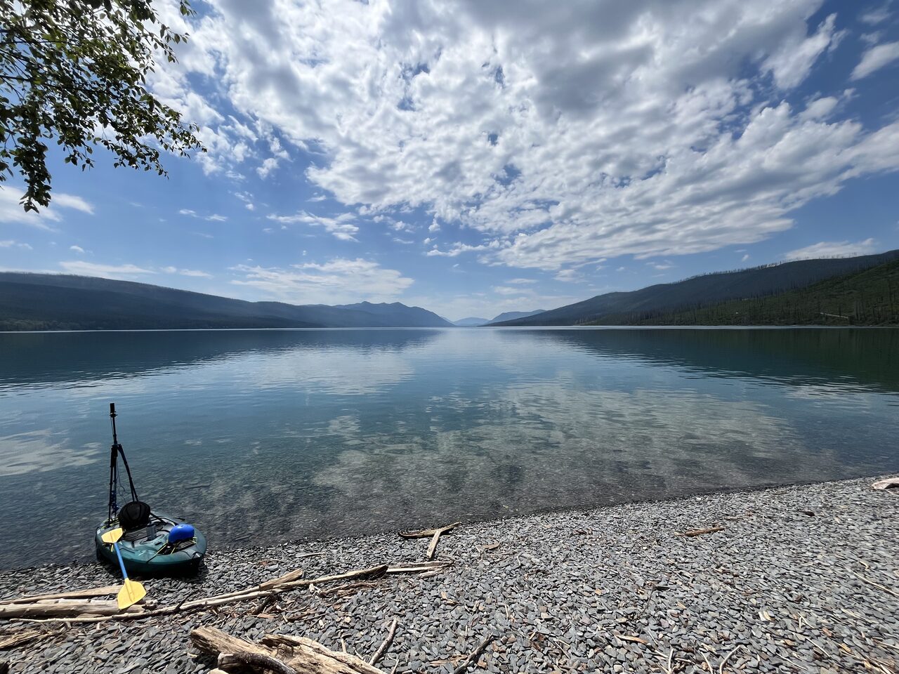 Lake McDonald and McDonald Creek in Glacier National Park, photographed from the water in July 2026