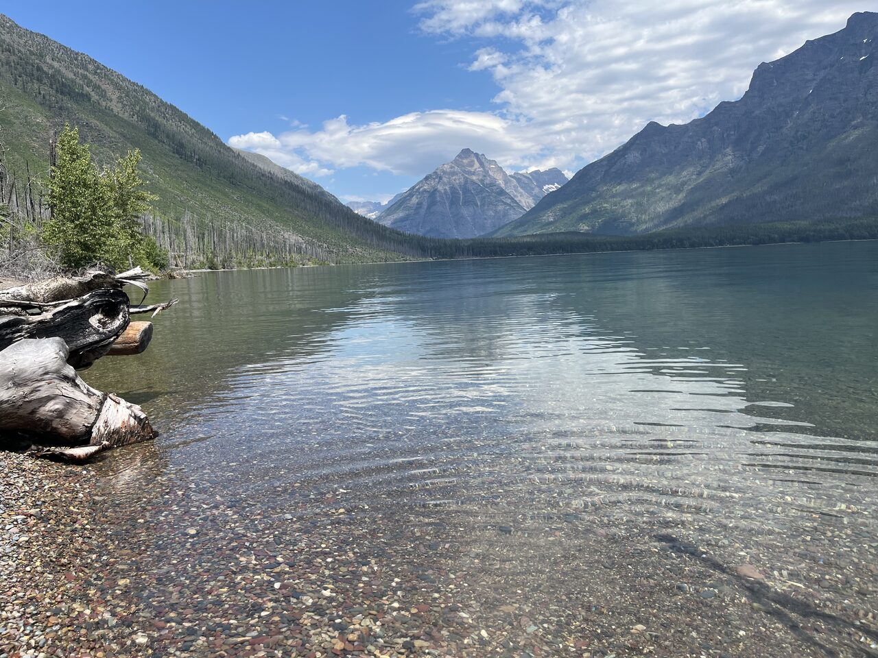 Lake McDonald and McDonald Creek in Glacier National Park, photographed from the water in July 2026