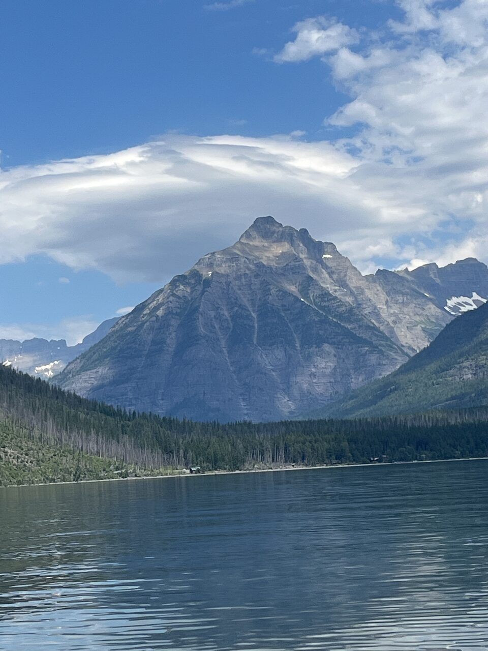 Lake McDonald and McDonald Creek in Glacier National Park, photographed from the water in July 2026