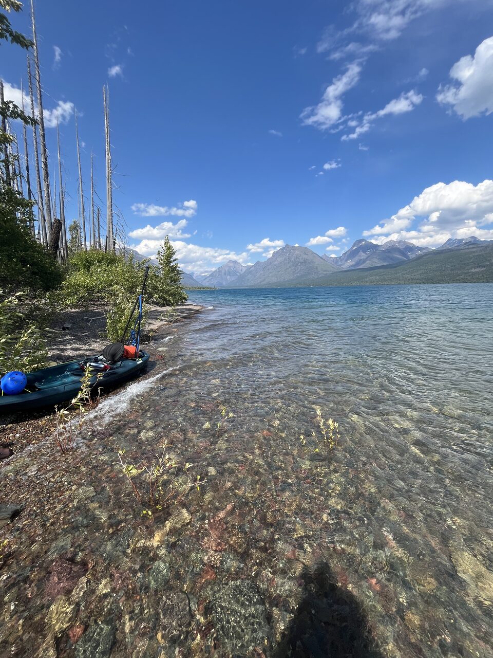 Lake McDonald and McDonald Creek in Glacier National Park, photographed from the water in July 2026
