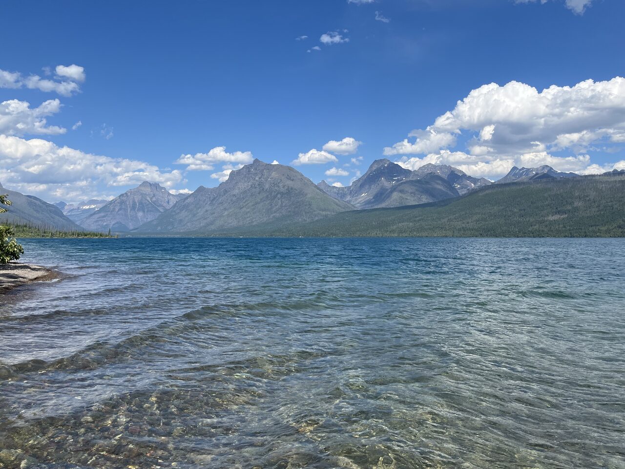 Lake McDonald and McDonald Creek in Glacier National Park, photographed from the water in July 2026